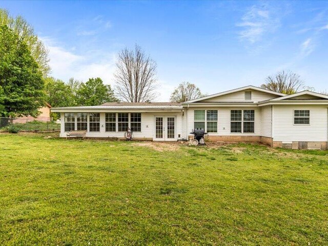 rear view of house with a yard and french doors