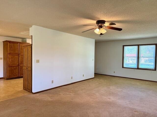700 Ridgeway, Mountain View, MO 65548 - spare room featuring ceiling fan, a textured ceiling, baseboards, and light carpet