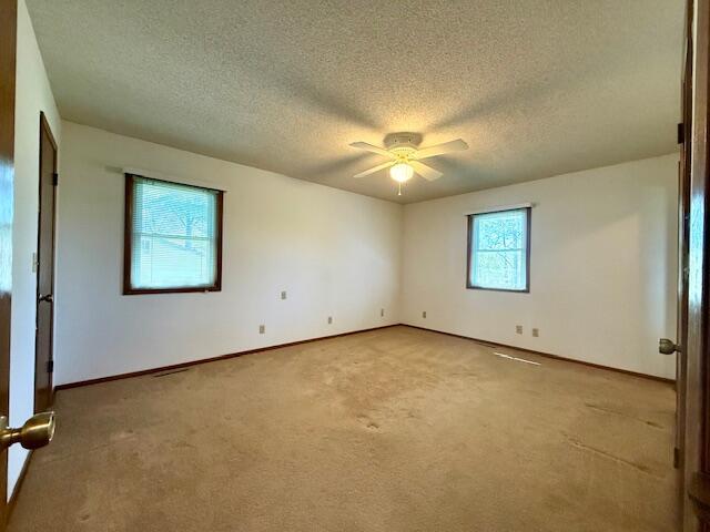 700 Ridgeway, Mountain View, MO 65548 - carpeted spare room with a textured ceiling, baseboards, and ceiling fan