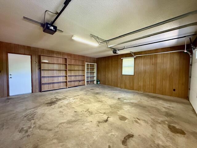 700 Ridgeway, Mountain View, MO 65548 - garage with wooden walls and a garage door opener