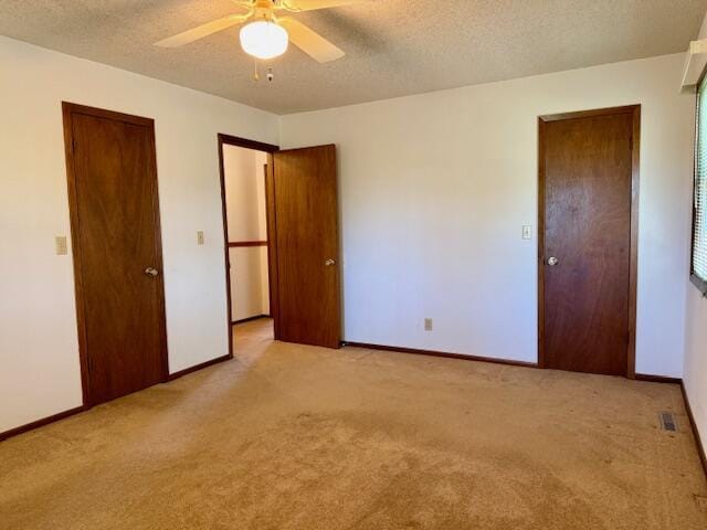 700 Ridgeway, Mountain View, MO 65548 - unfurnished bedroom with light carpet, baseboards, a textured ceiling, and ceiling fan