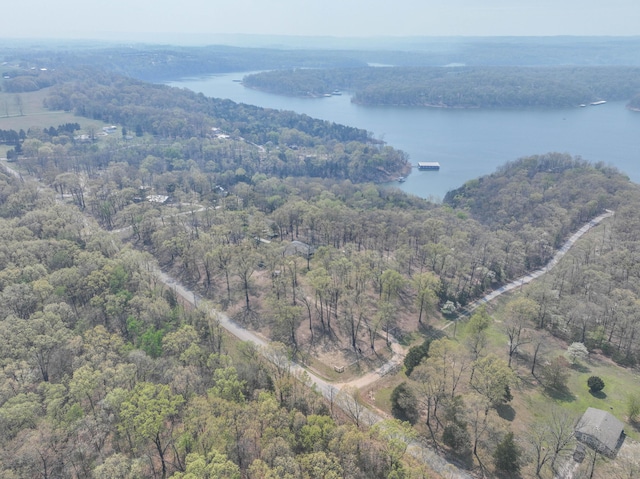 aerial view with a forest view and a water view