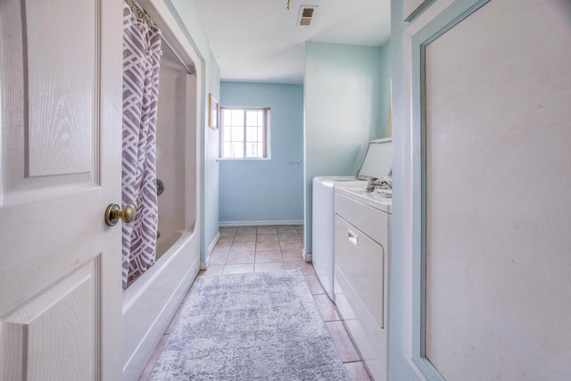 full bathroom with washer and dryer, shower / tub combo, baseboards, tile patterned flooring, and visible vents
