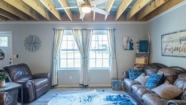 living room featuring baseboards, a ceiling fan, wood finished floors, and a healthy amount of sunlight
