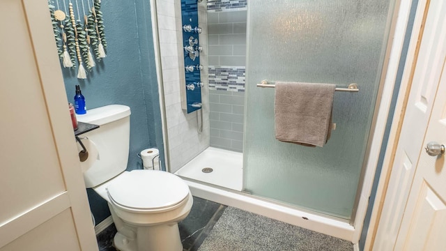 full bath featuring toilet, tile patterned floors, and a stall shower