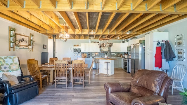 dining space featuring an inviting chandelier and wood finished floors