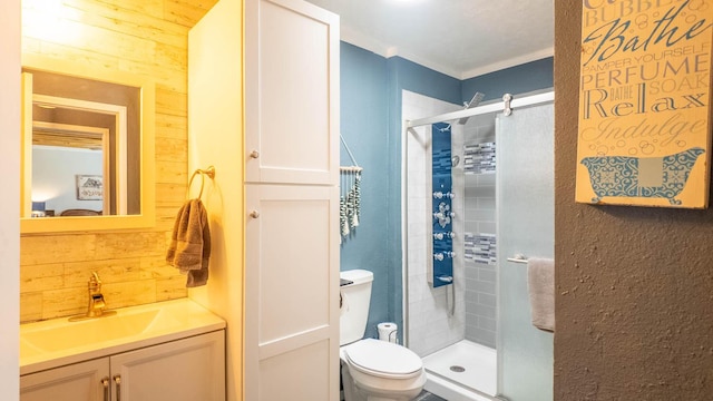 bathroom with toilet, a stall shower, wood walls, crown molding, and vanity