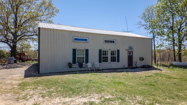 exterior space featuring a front lawn and metal roof