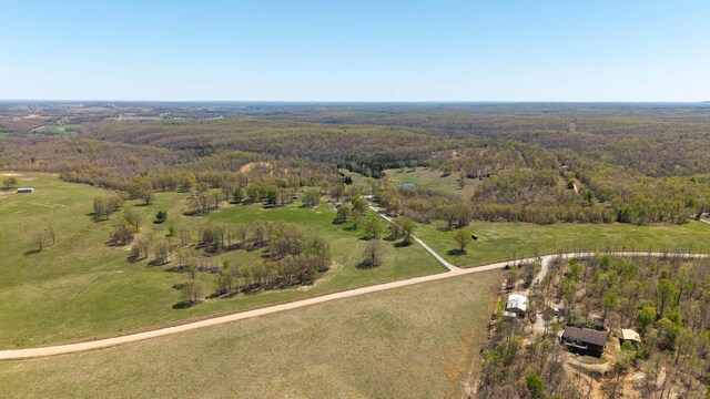 birds eye view of property with a view of trees