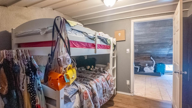 bedroom featuring baseboards and wood finished floors