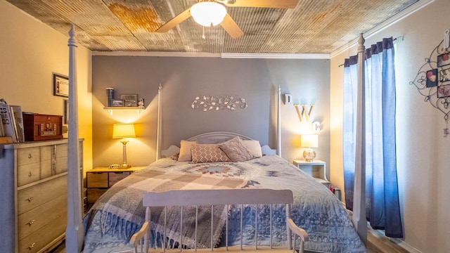 bedroom with a ceiling fan and crown molding