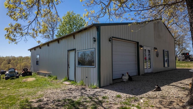view of outbuilding featuring a garage and an outbuilding
