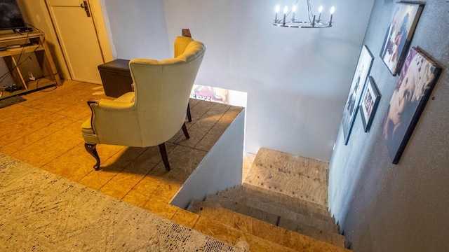 stairway featuring a chandelier and tile patterned floors