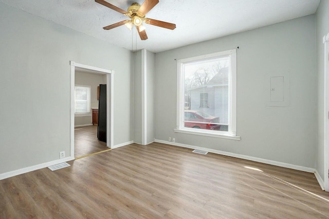 unfurnished bedroom featuring light wood finished floors, baseboards, and visible vents