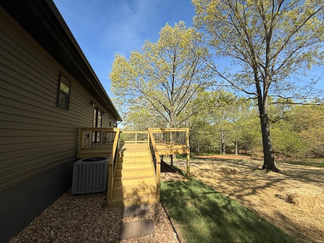 view of yard featuring central AC unit, stairway, and a deck