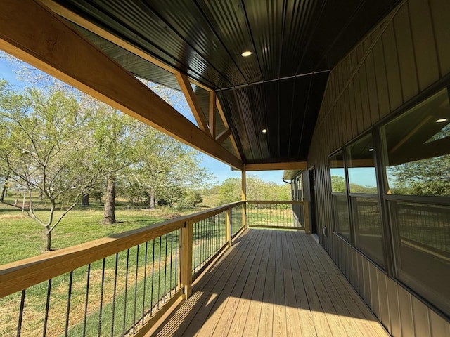 wooden deck with a lawn