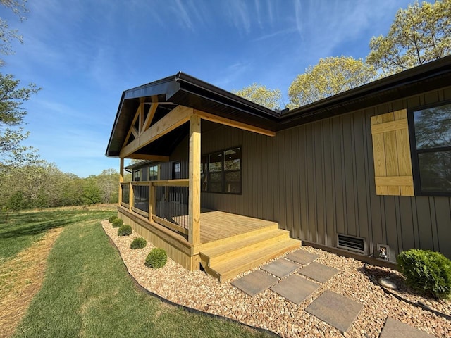 view of side of home featuring board and batten siding and a lawn
