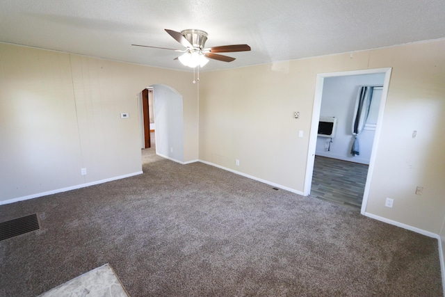 419 E Olive St, Bolivar, MO 65613 - empty room with carpet, visible vents, a ceiling fan, arched walkways, and baseboards