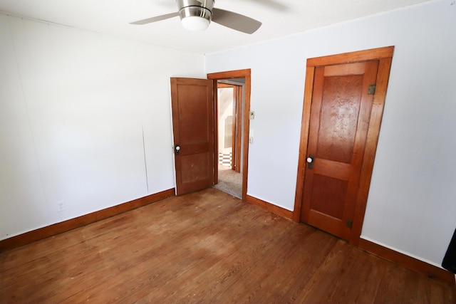 419 E Olive St, Bolivar, MO 65613 - unfurnished bedroom featuring ceiling fan, baseboards, and wood finished floors