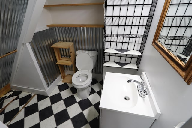 419 E Olive St, Bolivar, MO 65613 - bathroom with tile patterned floors, vanity, and toilet
