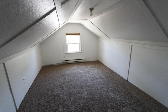 419 E Olive St, Bolivar, MO 65613 - bonus room featuring baseboard heating, vaulted ceiling, a textured ceiling, and carpet