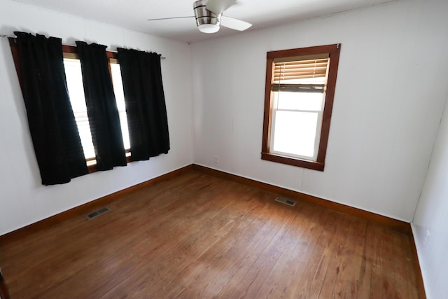 419 E Olive St, Bolivar, MO 65613 - empty room with baseboards, a ceiling fan, hardwood / wood-style floors, and visible vents
