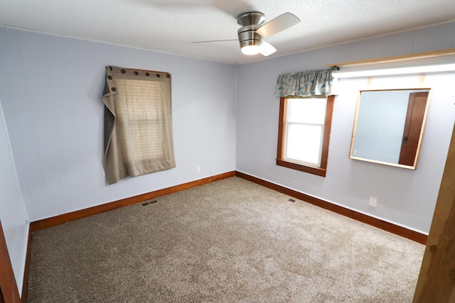 419 E Olive St, Bolivar, MO 65613 - empty room featuring baseboards, visible vents, carpet, and ceiling fan