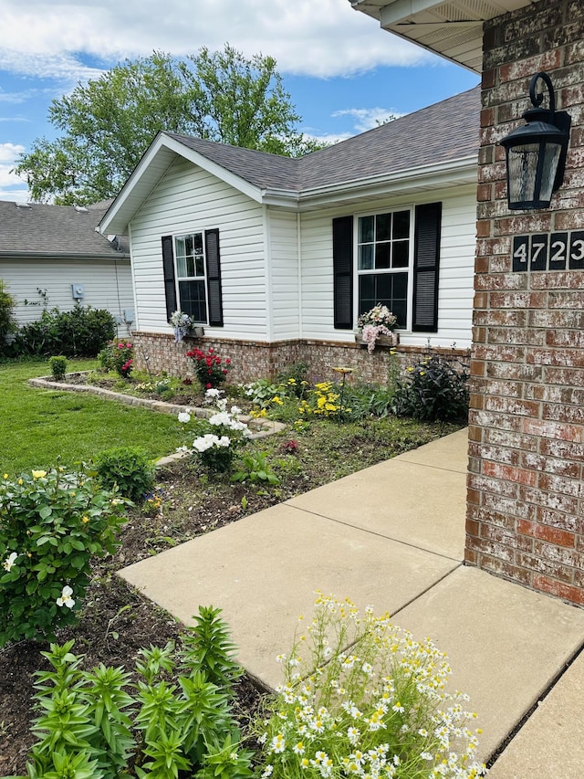 4723 W Portland St, Springfield, MO 65802 - doorway to property featuring brick siding and a shingled roof