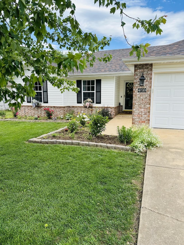 4723 W Portland St, Springfield, MO 65802 - ranch-style home featuring brick siding, a front yard, driveway, a garage, and a shingled roof