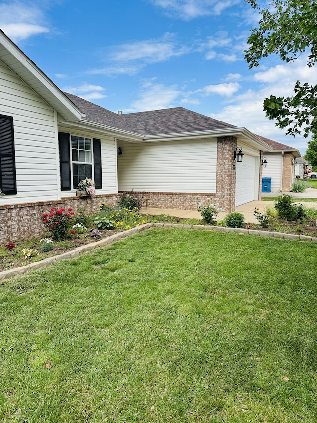 4723 W Portland St, Springfield, MO 65802 - view of front facade featuring brick siding, a garage, a front lawn, driveway, and a shingled roof