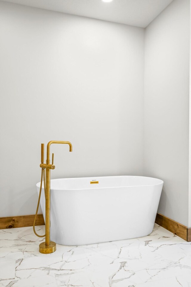 10560 State Highway U, Rogersville, MO 65742 - full bath featuring marble look tile flooring, baseboards, and a freestanding tub