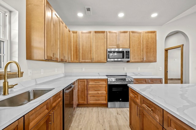 10560 State Highway U, Rogersville, MO 65742 - kitchen featuring stainless steel appliances, a sink, light wood-type flooring, light stone counters, and recessed lighting