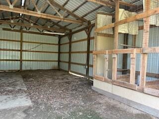 interior space with vaulted ceiling and metal wall