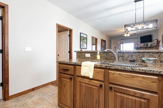 24 Village Trl Unit 5-8, Branson, MO 65616 - kitchen featuring brown cabinets, a sink, dark stone counters, hanging light fixtures, and ceiling fan