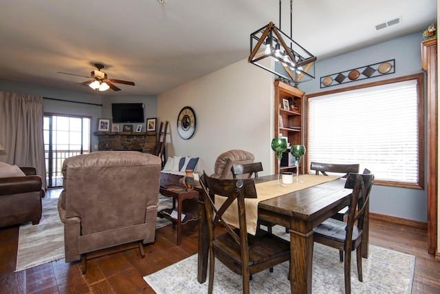24 Village Trl Unit 5-8, Branson, MO 65616 - dining space with dark wood-type flooring, visible vents, baseboards, and ceiling fan with notable chandelier