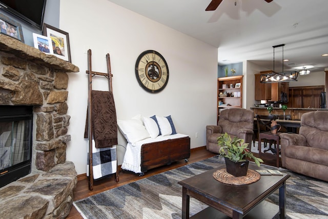 24 Village Trl Unit 5-8, Branson, MO 65616 - living room featuring a fireplace, wood finished floors, a ceiling fan, and baseboards