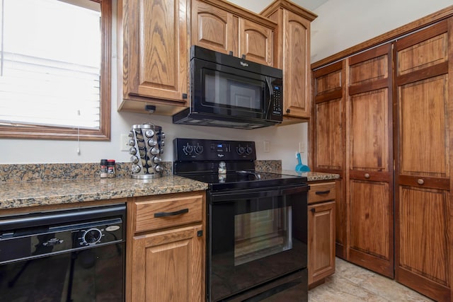 24 Village Trl Unit 5-8, Branson, MO 65616 - kitchen featuring brown cabinetry, stone counters, and black appliances