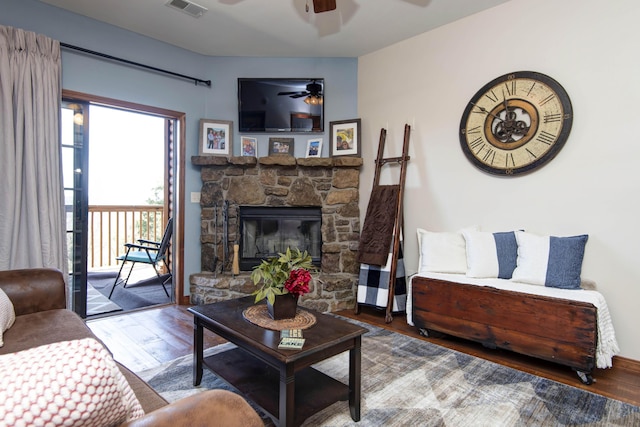 24 Village Trl Unit 5-8, Branson, MO 65616 - living area with wood finished floors, visible vents, a ceiling fan, and a stone fireplace