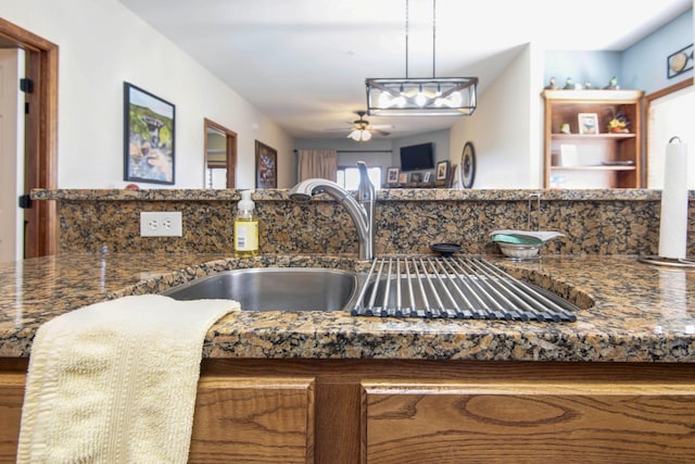 24 Village Trl Unit 5-8, Branson, MO 65616 - details featuring dark stone counters, ceiling fan, hanging light fixtures, and a sink