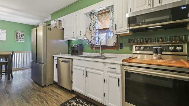 402 Lake, Mountain Grove, MO 65711 - kitchen with white cabinets, stainless steel appliances, a sink, and dark wood finished floors