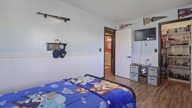 402 Lake, Mountain Grove, MO 65711 - bedroom featuring a walk in closet, wood finished floors, and a closet
