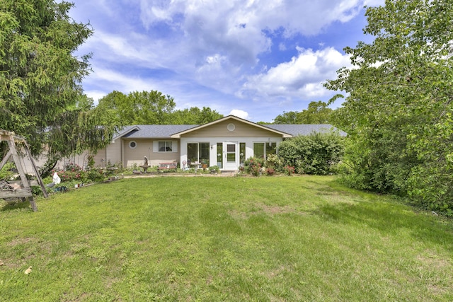 rear view of property with a lawn