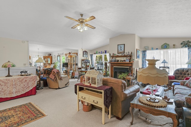 carpeted living area featuring ceiling fan, a fireplace, and lofted ceiling
