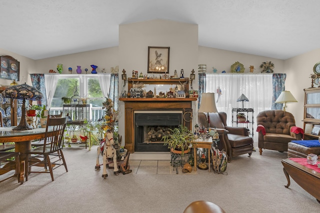 carpeted living room featuring a fireplace and lofted ceiling