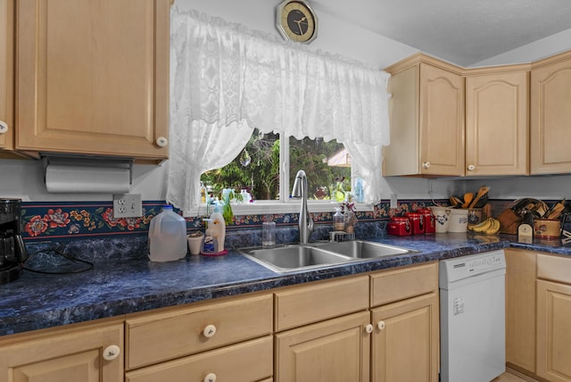 kitchen featuring a sink, light brown cabinetry, dark countertops, and dishwasher