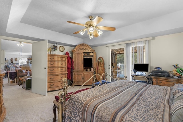 bedroom featuring a ceiling fan, a textured ceiling, light carpet, and access to exterior
