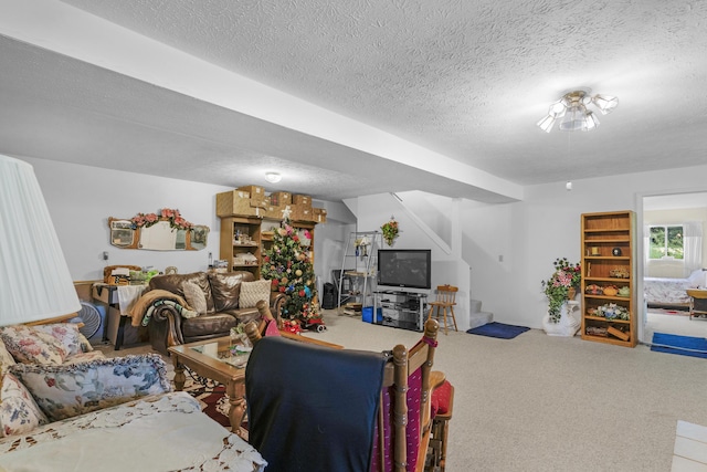 carpeted living room featuring stairs and a textured ceiling