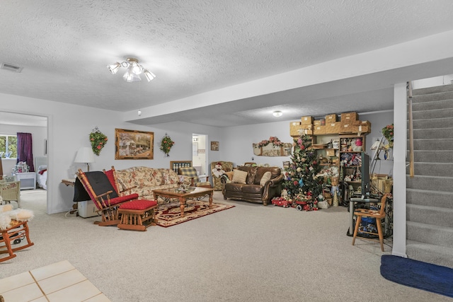 living room with stairway, carpet, a textured ceiling, and visible vents