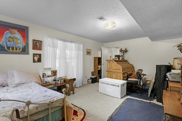 carpeted bedroom with visible vents and a textured ceiling