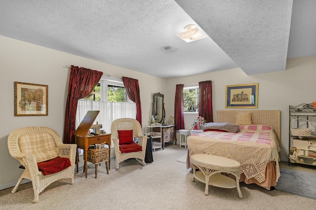 carpeted bedroom with a textured ceiling, visible vents, and multiple windows